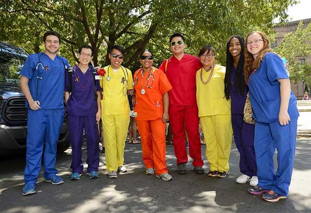 Healthcare workers wearing colored scrubs for pride.